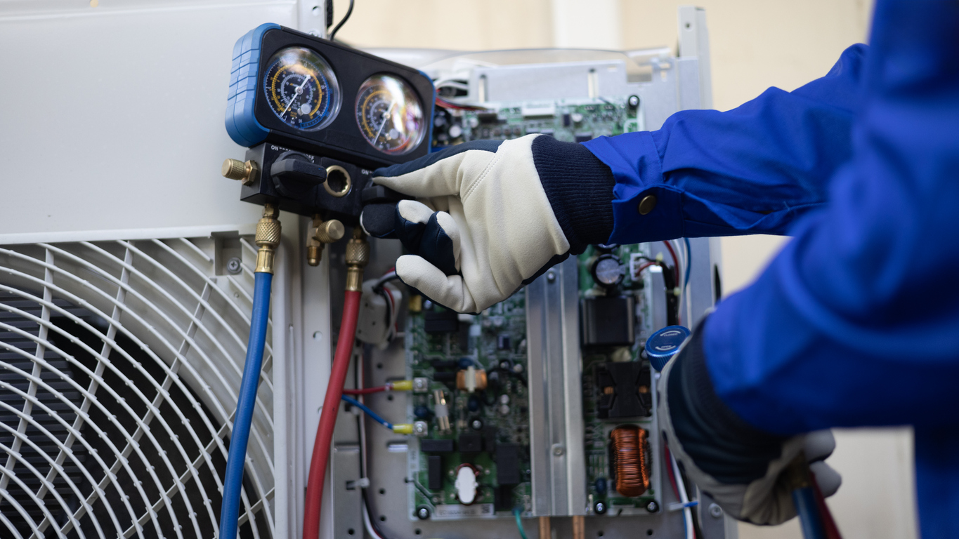 AC Repairman fixing a central AC unit