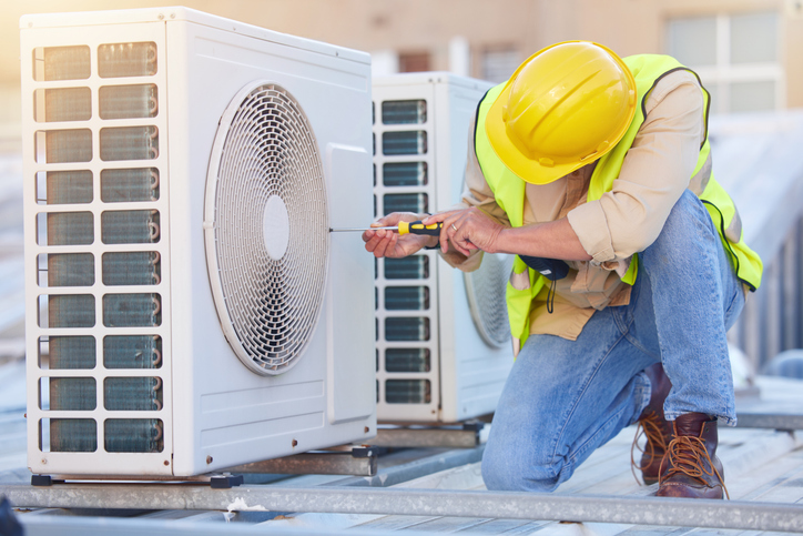 hvac technician working on a AC unit