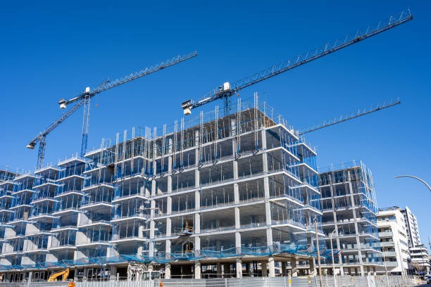 commercial bulding under construction with cranes