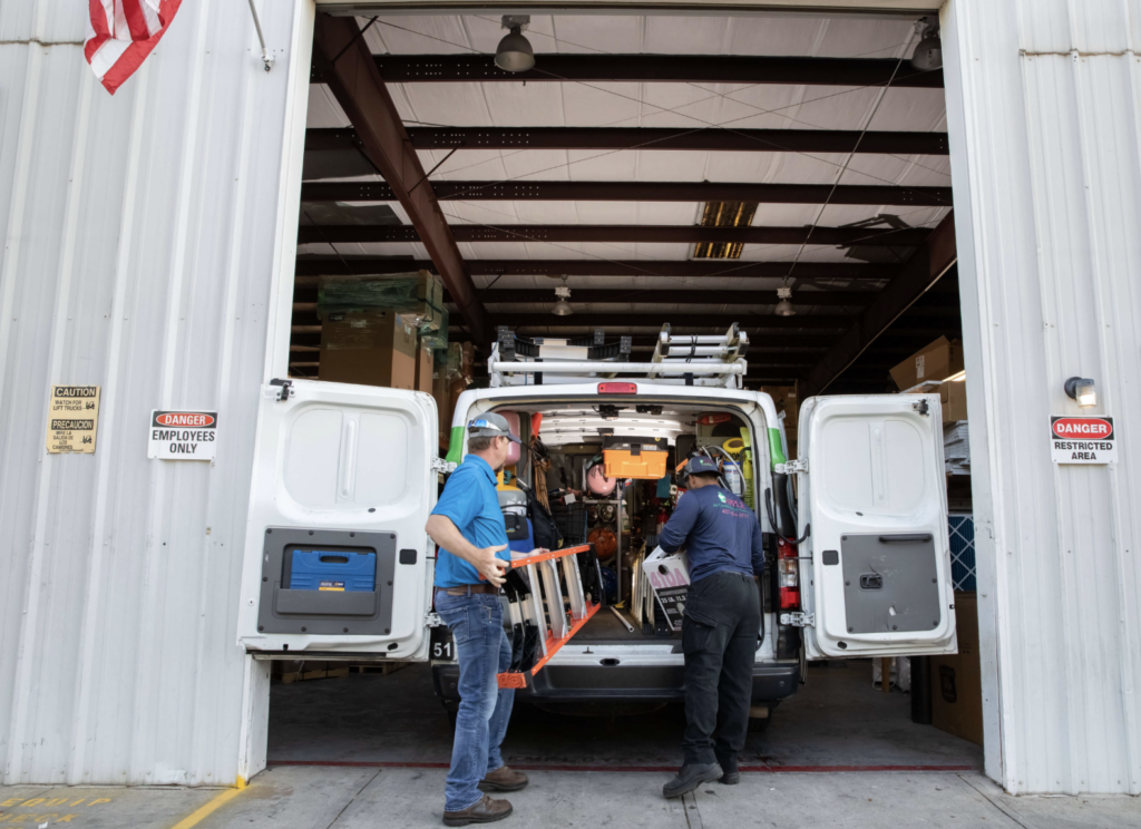 Apple AC workers loading up truck with supplies at warehouse in central Florida