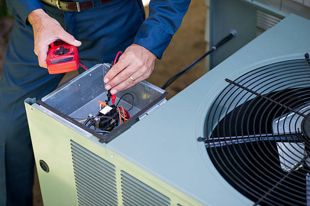 Air conditioner repairman in uniform using a volt meter.Take a look at my LIGHTBOXS with other related images.