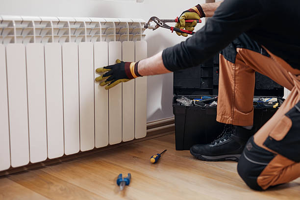 Central heating mechanic and handyman fixing home radiator, gas crisis and seasonal issues.