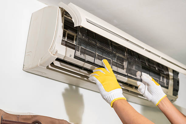 Cleaning air conditioner and reinstalling the dust filter in its correct position after cleaning.